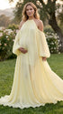 Pregnant woman wearing romantic light yellow maternity gown outdoors
