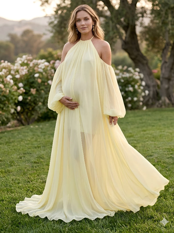 Pregnant woman wearing romantic light yellow maternity gown outdoors