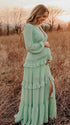 mint green lace trim maternity maxi dress with long sleeves and flowy tiered skirt