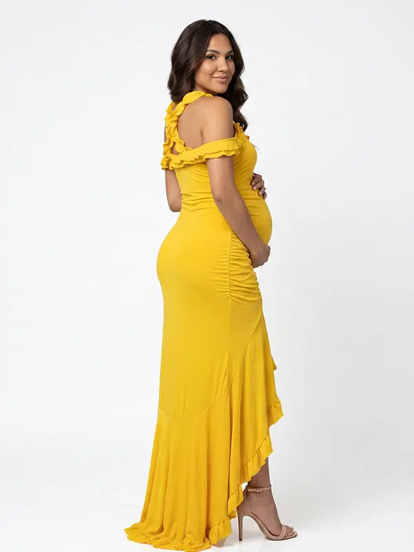 Mustard yellow ruffle halter maternity maxi dress with ruched bodycon silhouette and flowing high-low hem