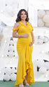 Mustard yellow ruffle halter maternity maxi dress with ruched bodycon silhouette and flowing high-low hem