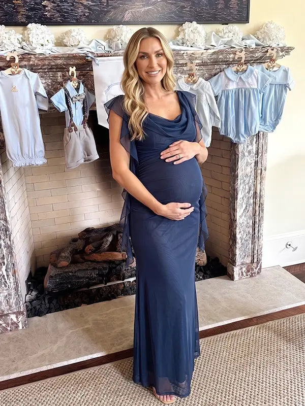 navy blue mesh maternity gown with draped neckline and cascading ruffle details