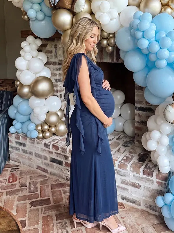 navy blue mesh maternity gown with draped neckline and cascading ruffle details