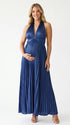 Pregnant model wearing a navy blue pleated satin halter maternity maxi dress with deep V neckline and flowing skirt for wedding guest, maternity photoshoot and formal occasions.