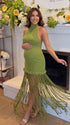 Olive green fringe halter maternity maxi dress with tassel hem, bodycon pregnancy gown for boho baby shower, rustic maternity photoshoot, outdoor pregnancy photography, and nature-inspired maternity portraits.