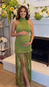Olive green fringe halter maternity maxi dress with tassel hem, bodycon pregnancy gown for boho baby shower, rustic maternity photoshoot, outdoor pregnancy photography, and nature-inspired maternity portraits.
