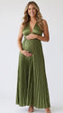Pregnant model wearing an olive green pleated satin halter maternity maxi dress with deep V neckline and flowing skirt for boho baby shower, rustic maternity photoshoot and outdoor pregnancy celebration.