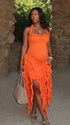 orange ruffle maternity dress with halter neckline and asymmetrical frill hem