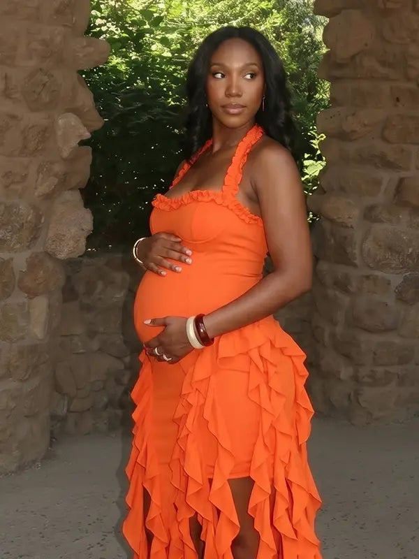 orange ruffle maternity dress with halter neckline and asymmetrical frill hem