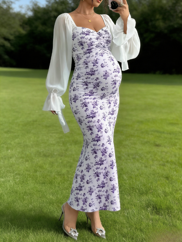 Pregrant showing baby bump in purple floral maternity dress