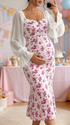 Side view of pregnant woman wearing red floral maternity maxi dress for baby shower