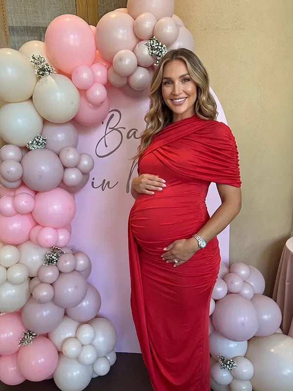red ruched maternity midi dress with matching shawl and bodycon silhouette