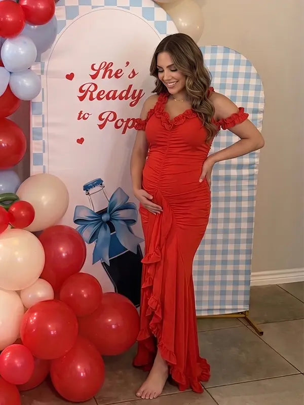 Red ruffle halter maternity maxi dress with ruched bodycon fit and flowing high-low hem