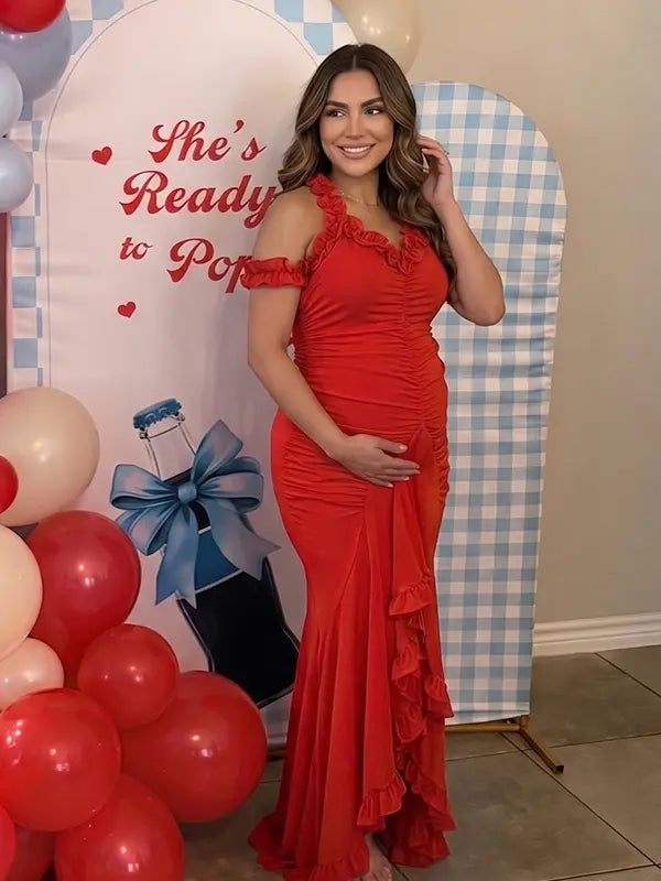Red ruffle halter maternity maxi dress with ruched bodycon fit and flowing high-low hem