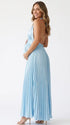 Pregnant model wearing a sky blue pleated satin halter maternity maxi dress with deep V neckline and flowing skirt for beach maternity photoshoot, coastal baby shower and destination pregnancy photography.
