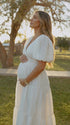 White v neck maternity maxi dress for baby shower, gender reveal and maternity photoshoot.