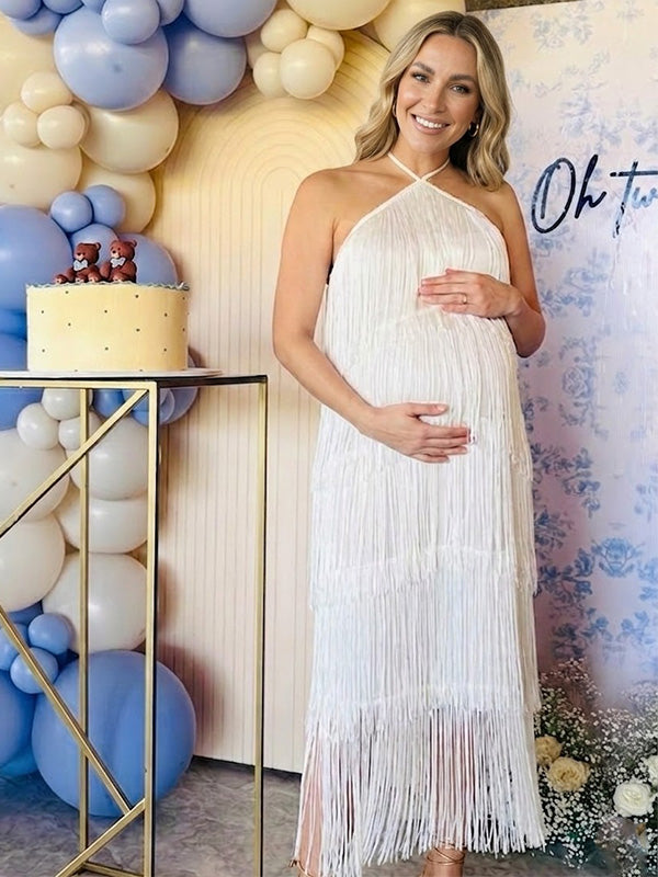 pregnant woman wearing white halter fringe maternity dress for baby shower