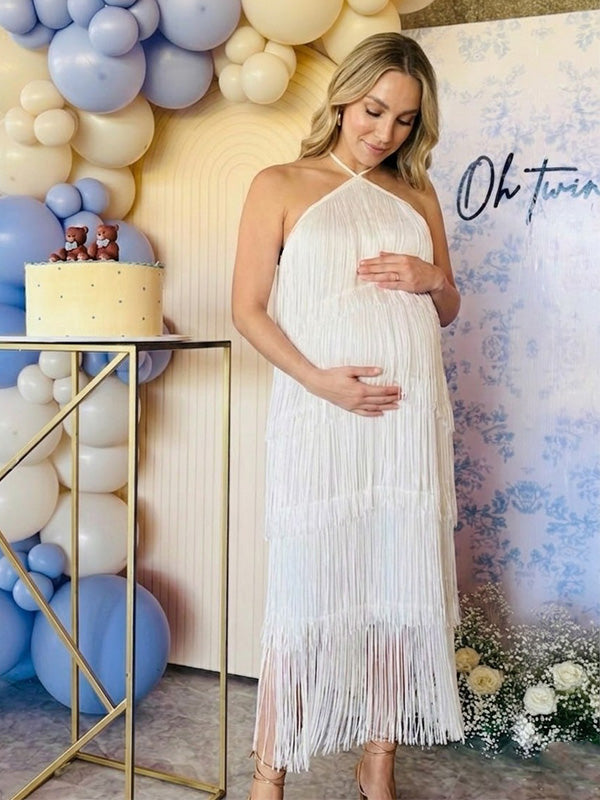pregnant woman wearing white halter fringe maternity dress for baby shower