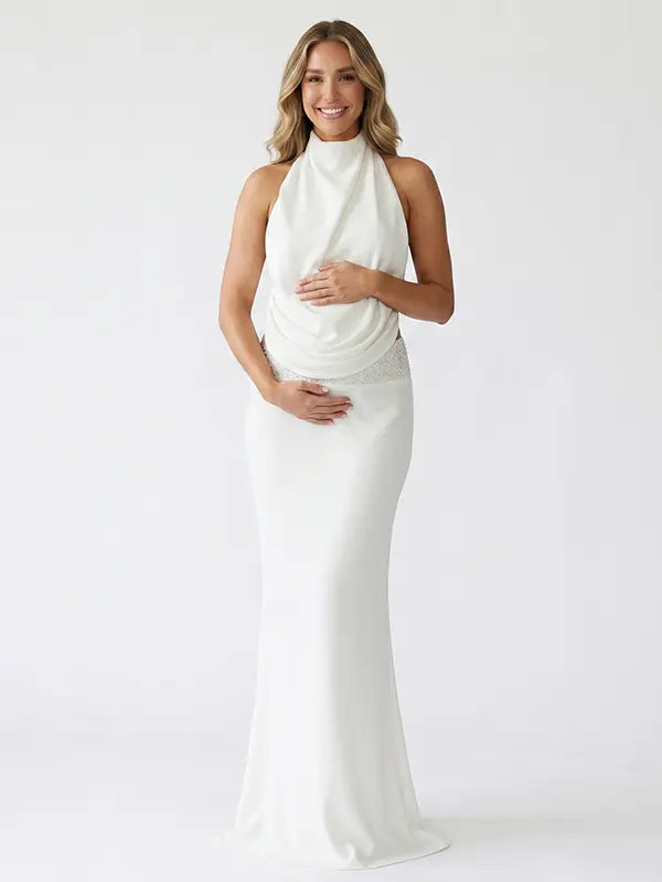 white halter maternity gown with open back design and pearl waist detail