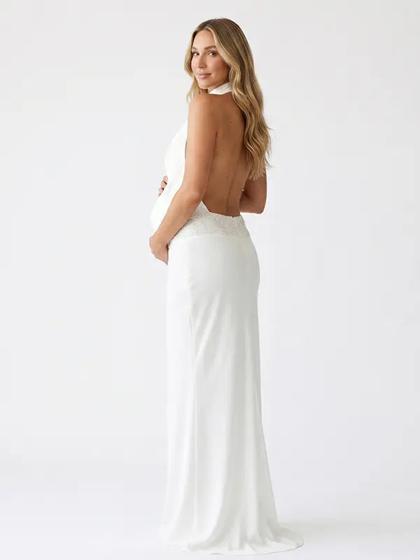 white halter maternity gown with open back design and pearl waist detail