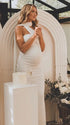 white halter maternity maxi dress with ruched bodycon silhouette and cross neck detail