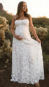 Pregnant woman wearing white floral open back maternity dress for baby shower
