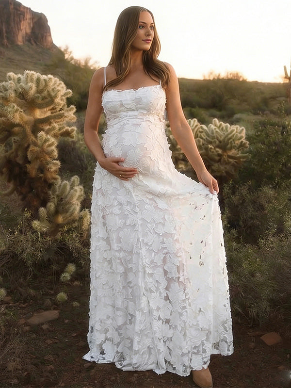 Pregnant woman wearing white floral open back maternity dress for baby shower
