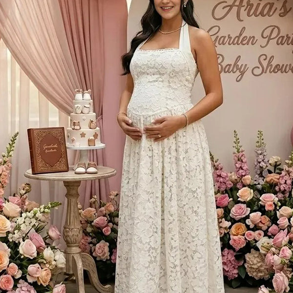 Pregnant woman wearing white lace halter maternity maxi dress at baby shower garden party