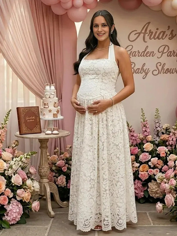 Pregnant woman wearing white lace halter maternity maxi dress at baby shower garden party