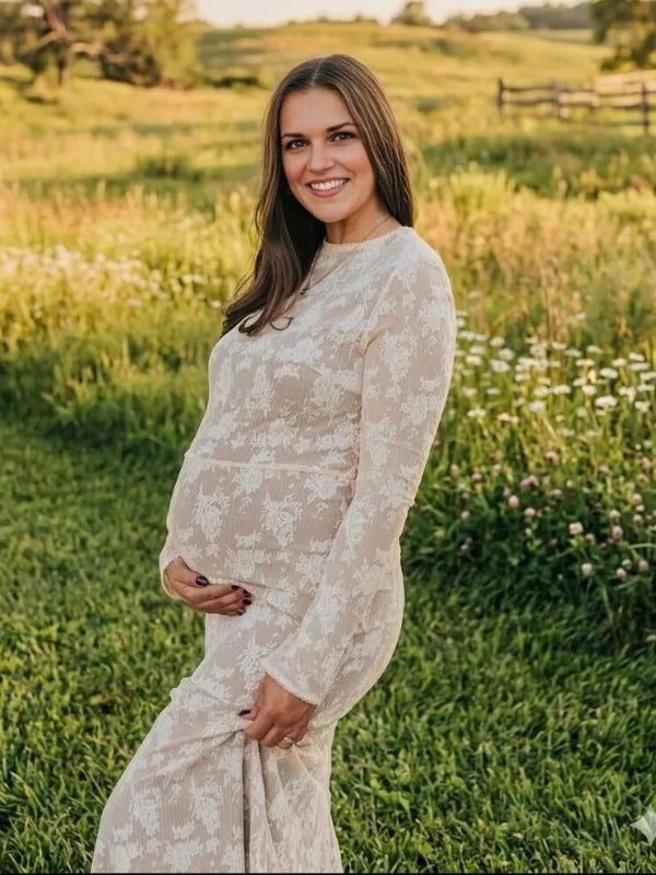 Pregnant woman wearing  elegant white maternity maxi dress for maternity photoshoot outdoors