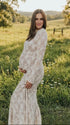 Pregnant woman wearing  elegant white maternity maxi dress for maternity photoshoot outdoors