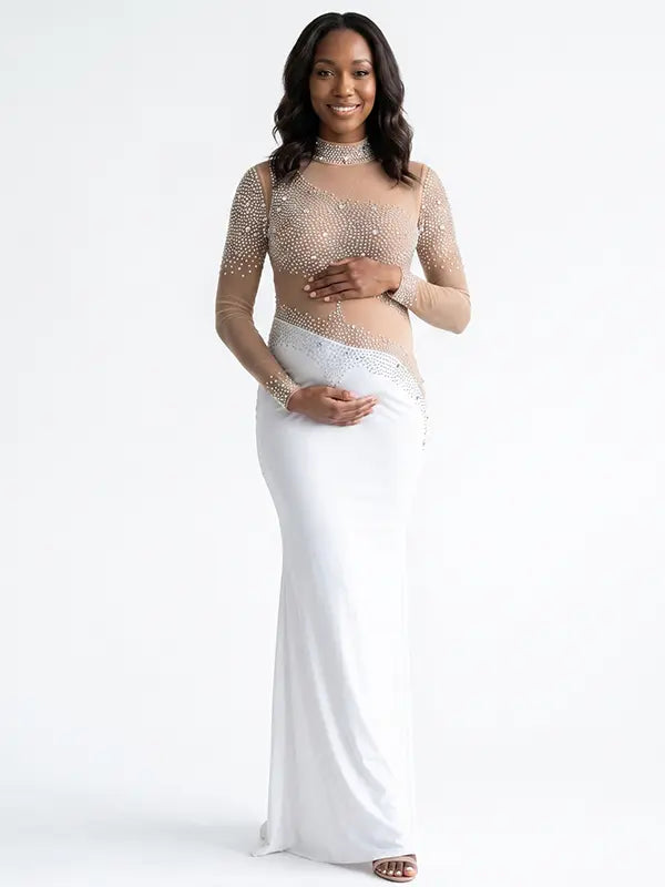 A white long sleeve rhinestone illusion mesh maternity mermaid maxi dress for luxury maternity photoshoots, baby showers, pregnancy announcements, and elegant formal events.