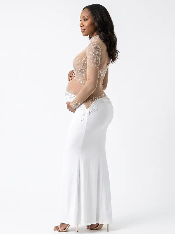 A white long sleeve rhinestone illusion mesh maternity mermaid maxi dress for luxury maternity photoshoots, baby showers, pregnancy announcements, and elegant formal events.
