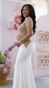 A white long sleeve rhinestone illusion mesh maternity mermaid maxi dress for luxury maternity photoshoots, baby showers, pregnancy announcements, and elegant formal events.