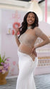 A white long sleeve rhinestone illusion mesh maternity mermaid maxi dress for luxury maternity photoshoots, baby showers, pregnancy announcements, and elegant formal events.