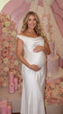 white off shoulder cowl neck maternity gown with open back detail and flowing silhouette