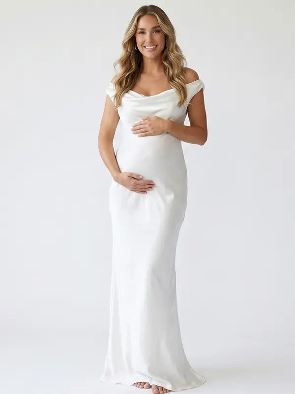 white off shoulder cowl neck maternity gown with open back detail and flowing silhouette