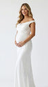 white off shoulder cowl neck maternity gown with open back detail and flowing silhouette