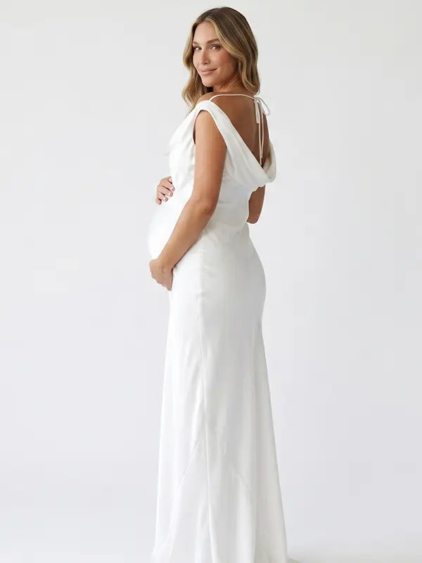 white off shoulder cowl neck maternity gown with open back detail and flowing silhouette