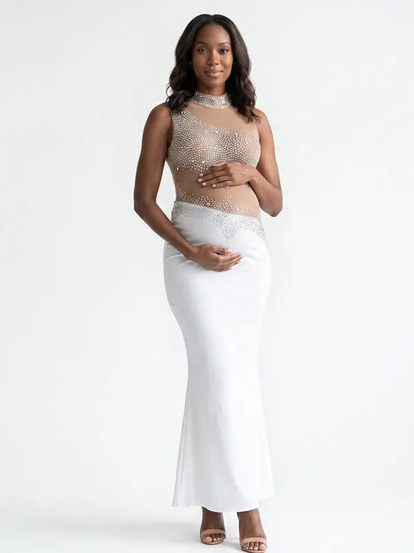 A white rhinestone illusion mesh maternity mermaid maxi dress for luxury maternity photoshoot, baby shower, editorial portrait, and pregnancy announcement.