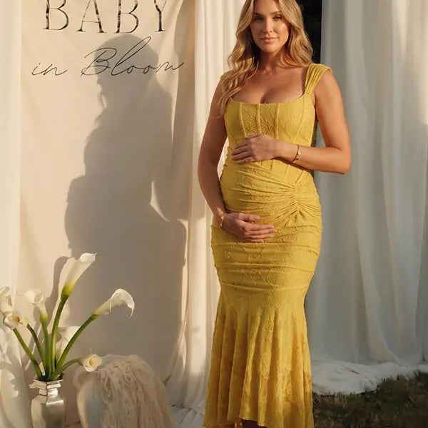 yellow jacquard maternity midi dress with corset bodice and high low hem