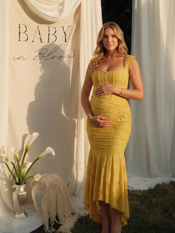 yellow jacquard maternity midi dress with corset bodice and high low hem